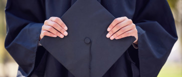 hands holding graduation cap