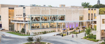 image of the K-State Student Union with purple lights in front of it.