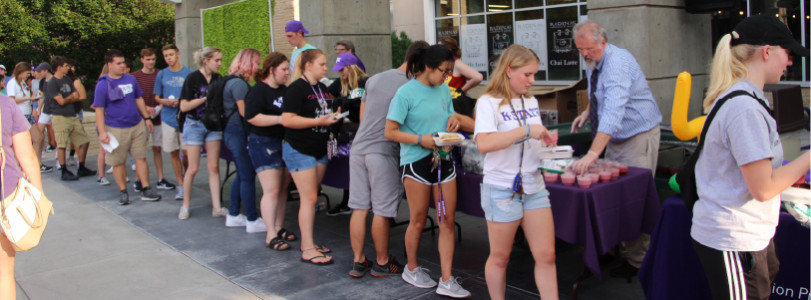 People lined up outside getting free items