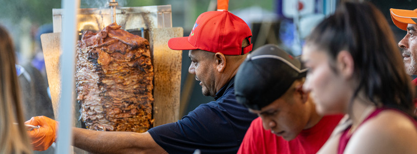 Three people serving food from a food truck