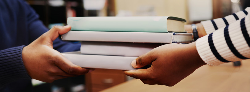 hands holding textbooks