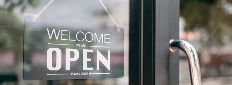 "Welcome, Open" sign on generic store door