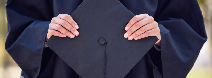 hands holding graduation cap