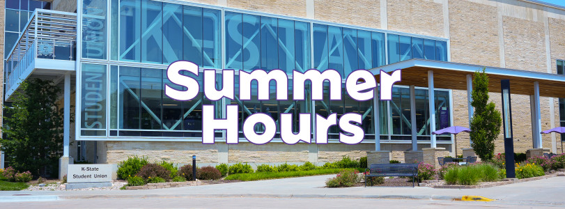Exterior view of the K-State Student Union on a sunny day, featuring a large glass facade with “K-State” displayed across the windows
