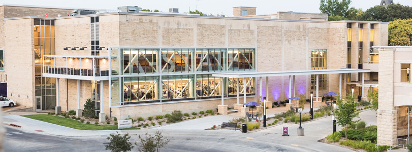 image of the K-State Student Union with purple lights in front of it.