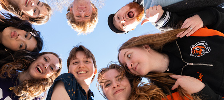 Union Student Employees gathered over a camera capturing their smiling faces and the sky