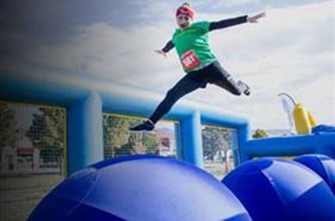 person on inflatable obstacle course