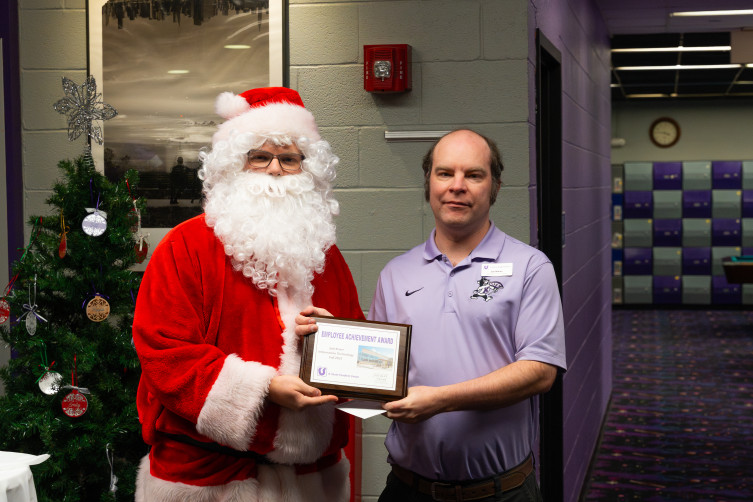 Joel Knarr accepts his Employee Achievement Award from Executive Director Erik Kahl